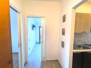 a kitchen with a sink and a door to a hallway at Il Ligustro Terrace in Casal Sottano