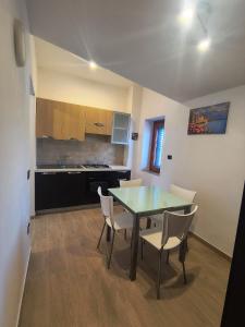 a kitchen with a dining room table and chairs at Il Ligustro Terrace in Casal Sottano
