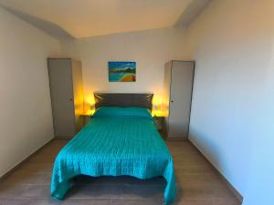 a bed with a blue bedspread in a room at Il Ligustro Terrace in Casal Sottano