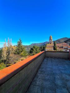 a wall on top of a building with mountains in the background at Il Ligustro Terrace in Casal Sottano