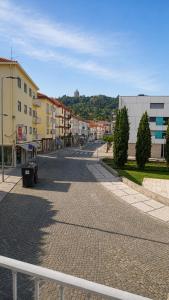 an empty street in a town with buildings at Dona Emília Mercado in Viana do Castelo