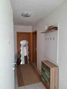 a hallway of a house with a sign on the floor at Apartman Mostar in Mostar +1 photo