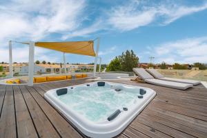 a jacuzzi tub on a wooden deck at Vilamoura 4-Bedroom Penthouse with Jacuzzi in Vilamoura
