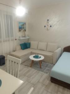 a living room with a couch and a table at Studio Dream 30m od plaze in Đenovići