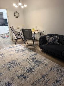 a living room with a couch and a table at The cozy escape in Satu Bucovei