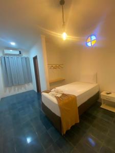 a bedroom with a bed in a room at Santa Ana da Ribeira in SantʼAnna do Ipanema