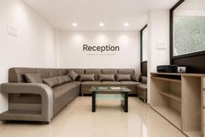 a living room with a couch and a coffee table at Hotel Sawaastic in Calangute North GOA in Calangute