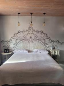 a bedroom with a large white bed with two tables at Bomotel in Montluçon