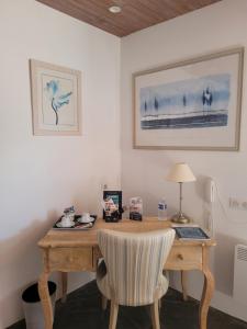 a wooden desk with a chair in a room at Bomotel in Montluçon +25 photos