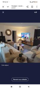 a living room with couches and a tv at Villa Oasis Bollène in Bollène
