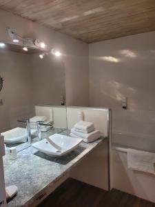 a bathroom with a sink and a large mirror at Bomotel in Montluçon
