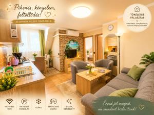 a kitchen and a living room with a couch and a table at Apartman Siesta Bük - Bükfürdő in Bük