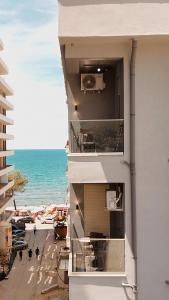 a building on the beach with a view of the ocean at EBIS HOTEL in Shëngjin