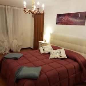 a bedroom with a large red bed in a room at Residenza al Volto in Venice