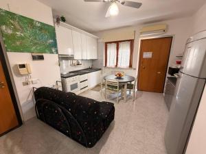 a kitchen with a couch and a table in a kitchen at Ro's House in Assemini