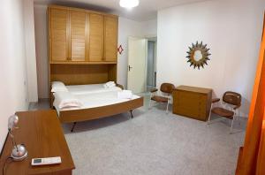a bedroom with a bed and a table and chairs at Ro's House in Assemini