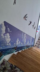 a box with a painting of the ocean and birds at APPLE PARADISE, House of mirrors, self check-in, FREE PARKING in Riga