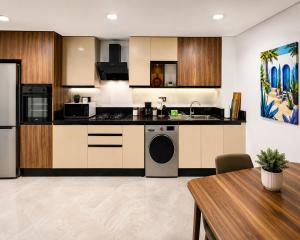 a kitchen with a stove and a dishwasher at Le Jardin Secret - Pool View Elegance in Mohammedia