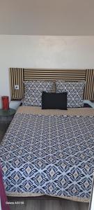 a bedroom with a bed with a blue and white bedspread at Cap Esterel vue Mer in Agay - Saint Raphael +24 photos