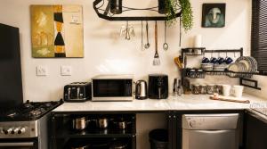 a kitchen with a stove and a microwave on a counter at Gadute Haven - Luxury Apartment in Pretoria