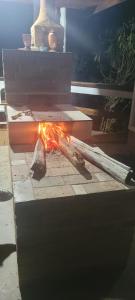 a stick is on fire in front of a fountain at Estalagem Sitio Colibri in Cunha