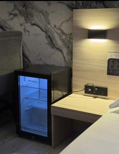 a room with a bed and a small refrigerator at Van park hotel in Shymkent