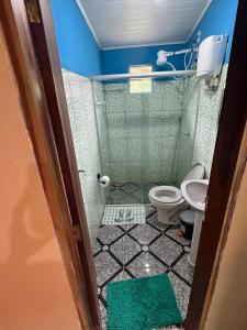 a small bathroom with a toilet and a sink at Chalé Raio De Sol in Vale do Capao +40 photos