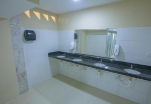 a bathroom with two sinks and a mirror at Pousada Estrela Dourada in João Pessoa +7 photos