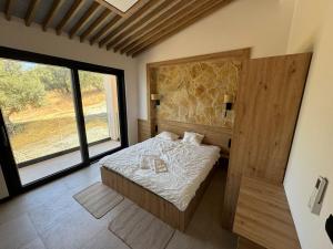 a bedroom with a bed and a large window at villa efraim read the details from the host for approval in Athens +8 photos