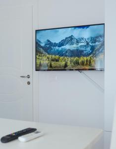 a flat screen tv hanging on a wall in a room at EBIS HOTEL in Shëngjin