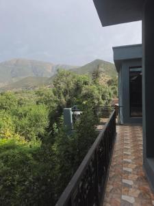 a balcony of a house with a view of the mountains at La Maison Nature , Mountains View Suite in Ourika