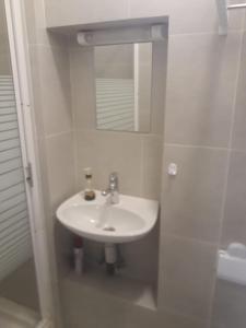 a white bathroom with a sink and a mirror at La Maison Nature , Mountains View Suite in Ourika +5 photos