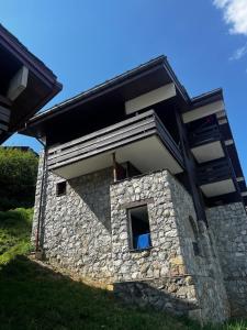 a stone house with a window on the side of it at Chaletttt large and magnificent view in Valmorel