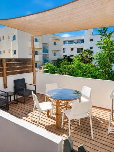 a patio with a table and chairs on a deck at Formentera suite 14 in Es Pujols