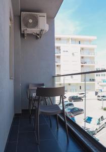 a balcony with a table and a air conditioner at EBIS HOTEL in Shëngjin