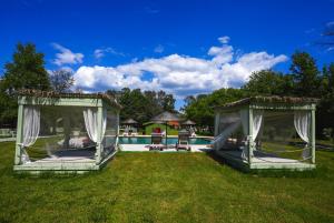 two gazebos in a yard next to a pool at Dalyan Riverside Private Gaia Koru Bungalows with Swimming Pool Adults Only in Ortaca