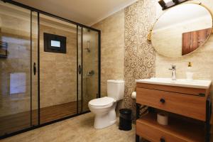 a bathroom with a toilet and a sink and a mirror at Dalyan Riverside Private Gaia Koru Bungalows with Swimming Pool Adults Only in Ortaca