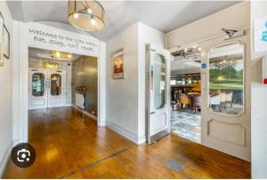 a living room with a hard wood floor and white walls at The Fairways Pub in Templebrough