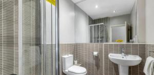 a bathroom with a toilet and a sink at The Fairways Pub in Templebrough +11 photos