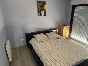 a bedroom with a bed with two pillows on it at Normandy lodges in Le Dézert