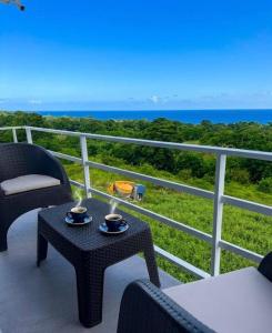 a balcony with chairs and tables and the ocean at Rico Puerto magic spot east in Cabrera