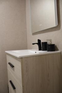 a bathroom vanity with a sink and a mirror at La Divina 1 in Ribadavia