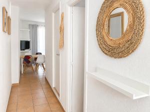 a hallway with a mirror and a table at Formentera suite 14 in Es Pujols