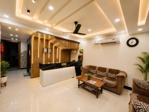 a living room with a couch and a table at Sitara Premium Dhakad Gold, Near Lakshman Jhula, Tapovan in Rishīkesh