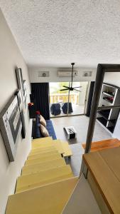 a living room with stairs leading up to a house at Caribbean apartment in Cancún