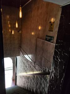 a staircase in a building with a stone wall at Hotel Cacique in Socorro