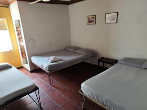 a room with two beds in a room at Hotel Cacique in Socorro