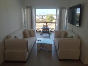a living room with two couches and a table at Rinconcito Caribeno Apartment in San Pedro de Macorís