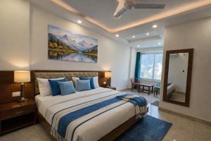 a bedroom with a large bed and a large window at Sitara Premium Dhakad Gold, Near Lakshman Jhula, Tapovan in Rishīkesh