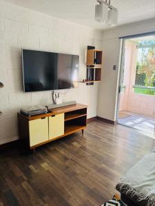 a living room with a flat screen tv on a wall at Refugio las pircas in Vicuña